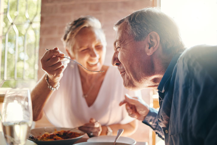 woman feeding a man at the restaurant