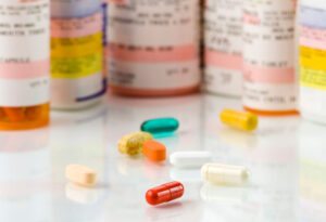 mixed pills and prescription bottles