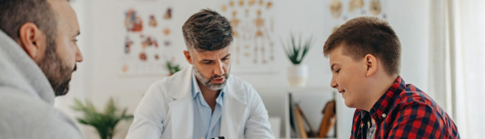 overweight teen boy talking with nutritionist in office