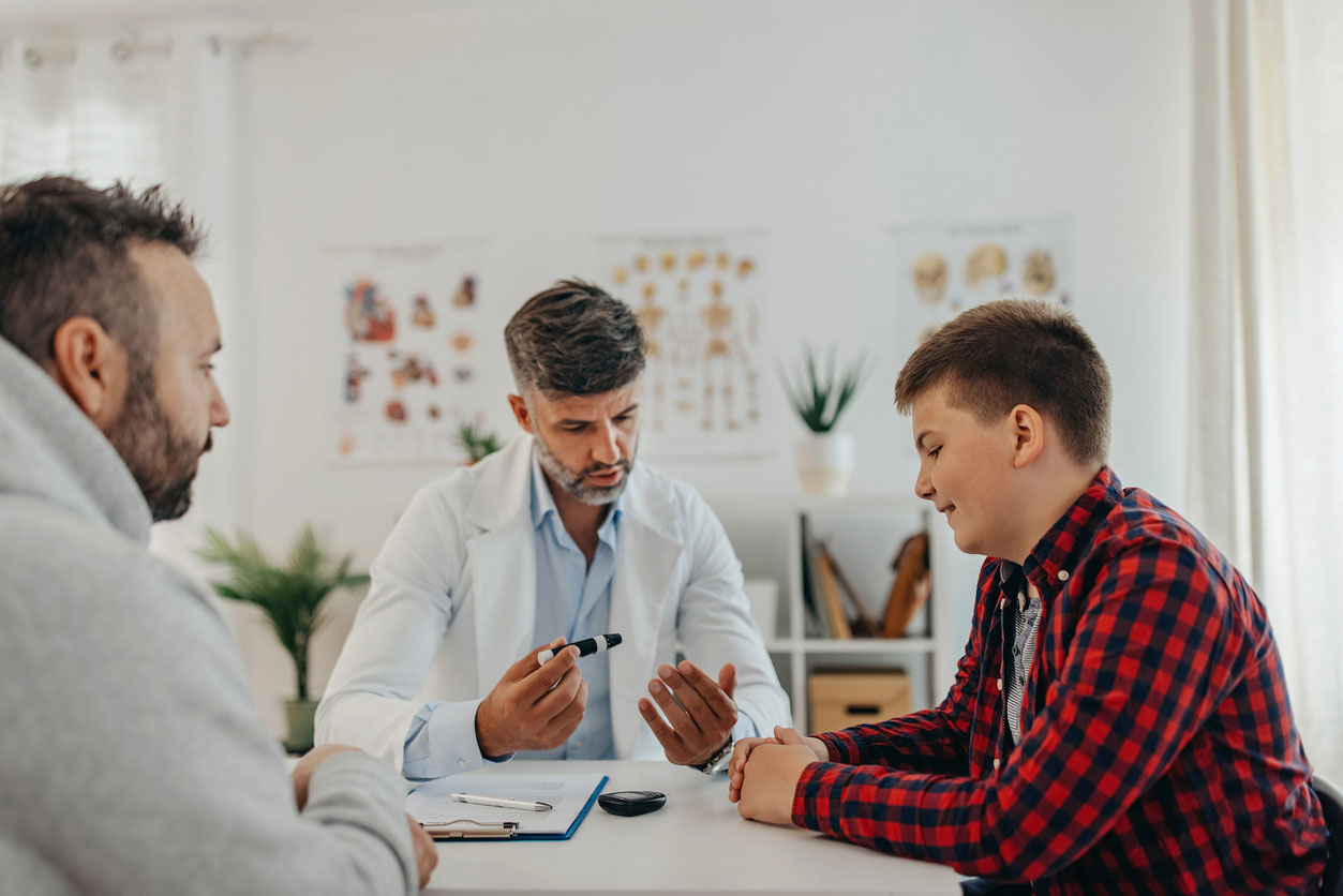 overweight teen boy talking with nutritionist in office